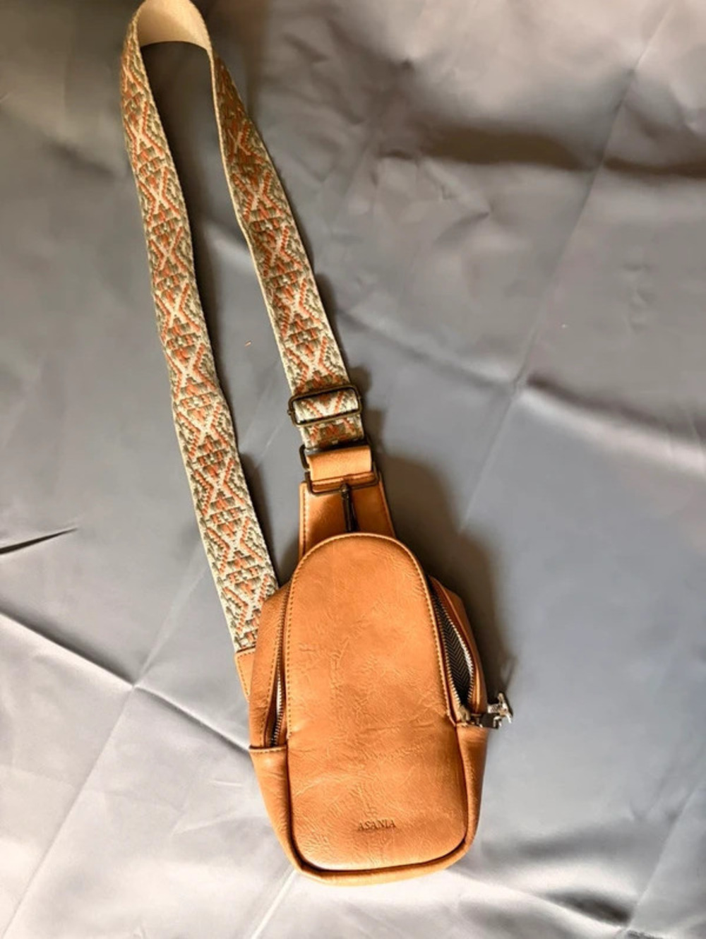 Tan leather crossbody bag with woven strap